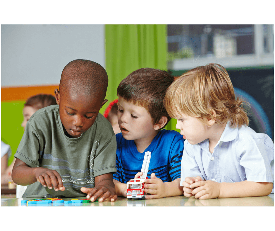 3 toddlers playing together developing social skills at early childhood development class