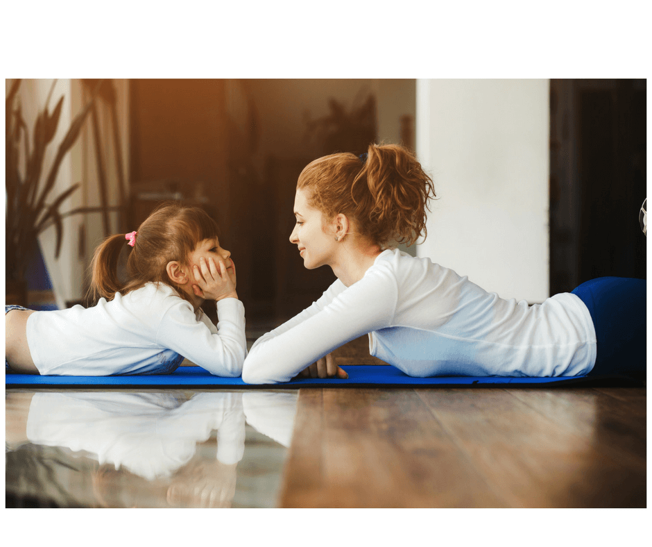 mother and daughter talking lying on the floor