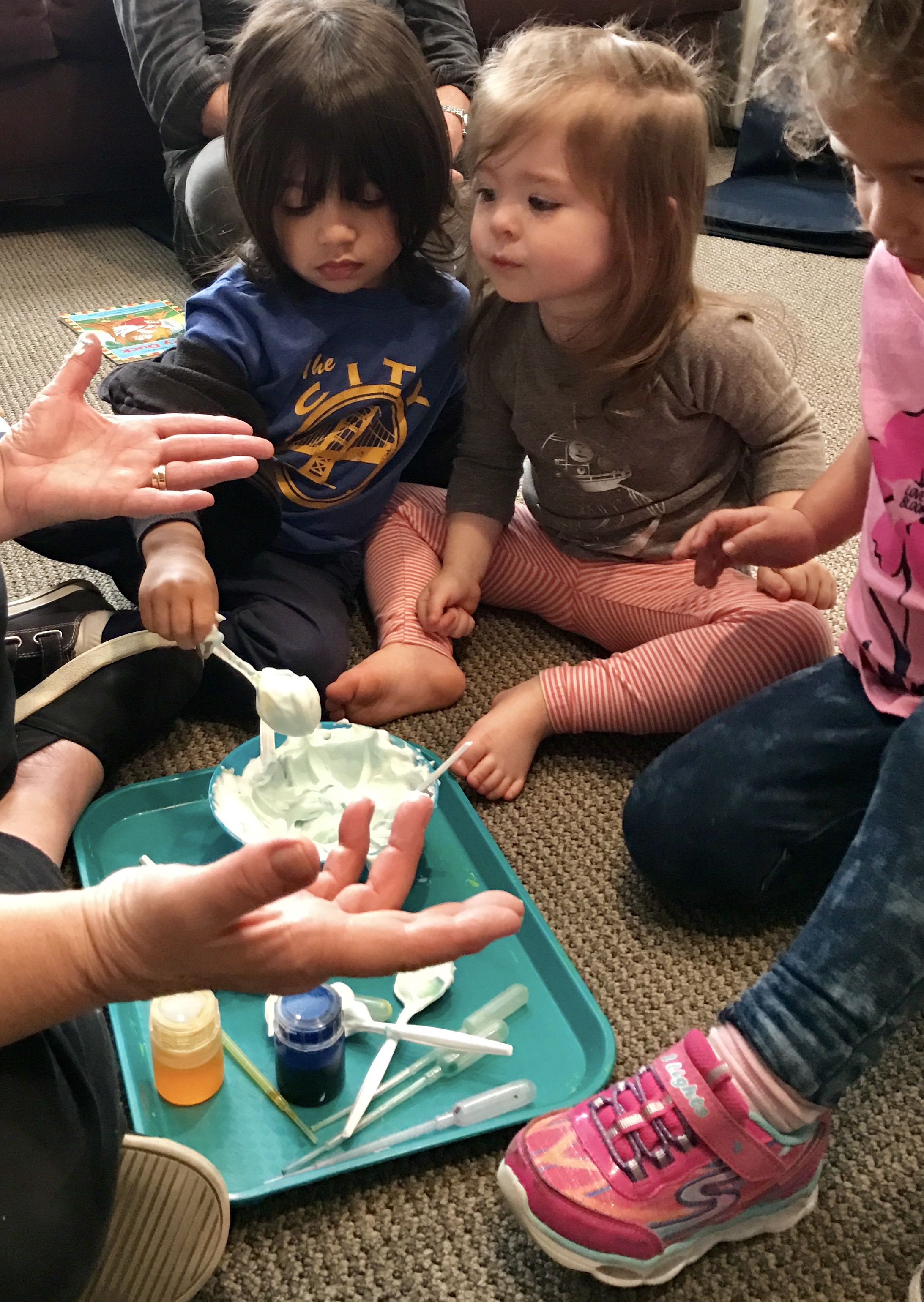 children leaning with paint at early childhood development class