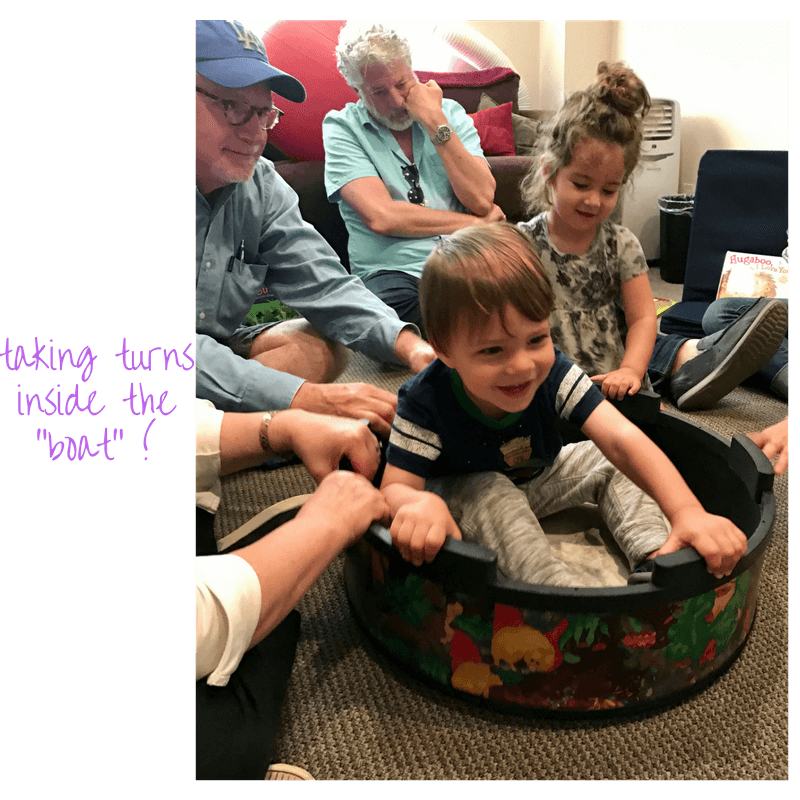 toddlers playing inside a pretend boat at early childhood development class