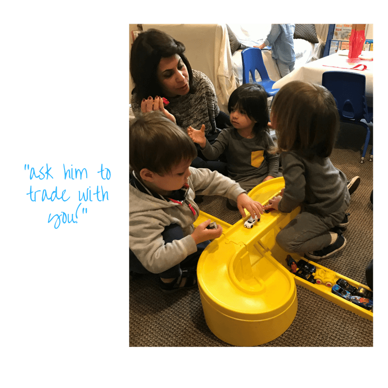 adult teaching toddlers how to play together with cars trading and taking turns at early childhood development class