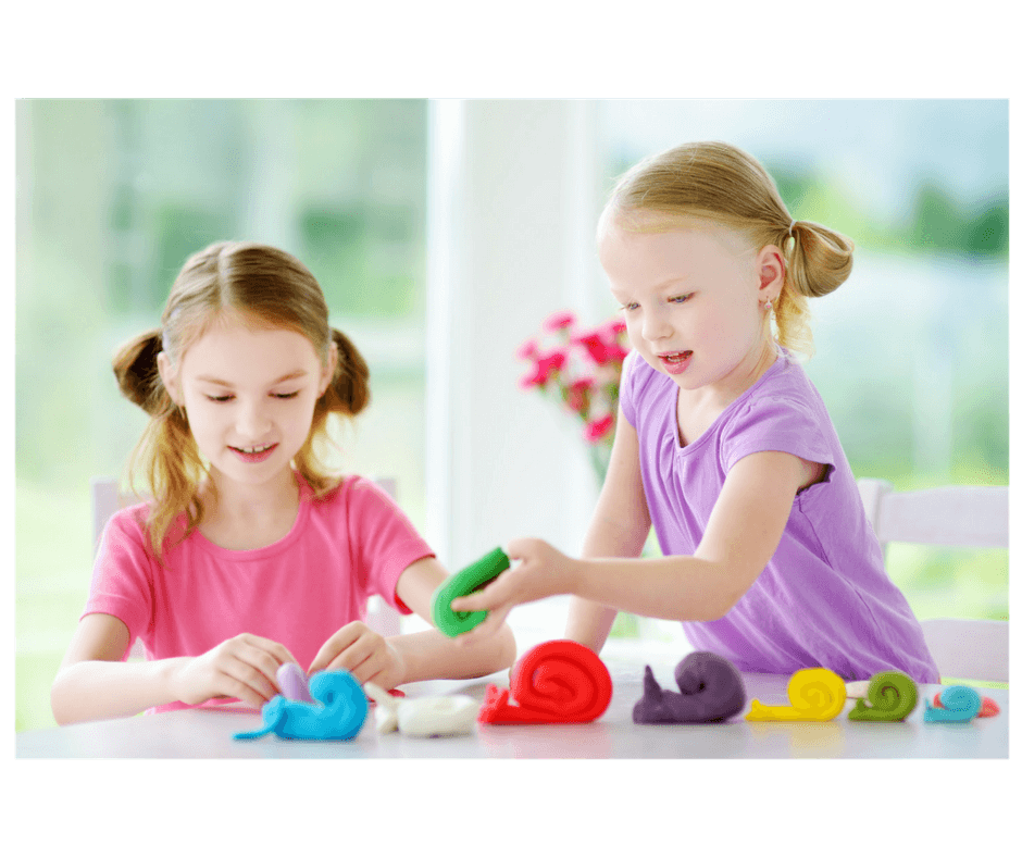 2 girls playing together with playdoh