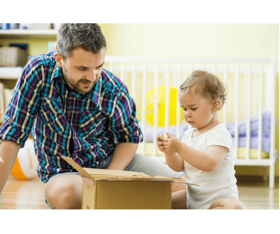 dad helping child sort out toys to play and to keep in a box