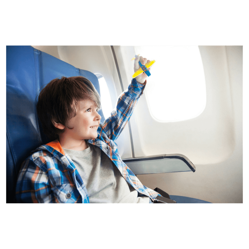 toddler boy sitting and playing on the airplane