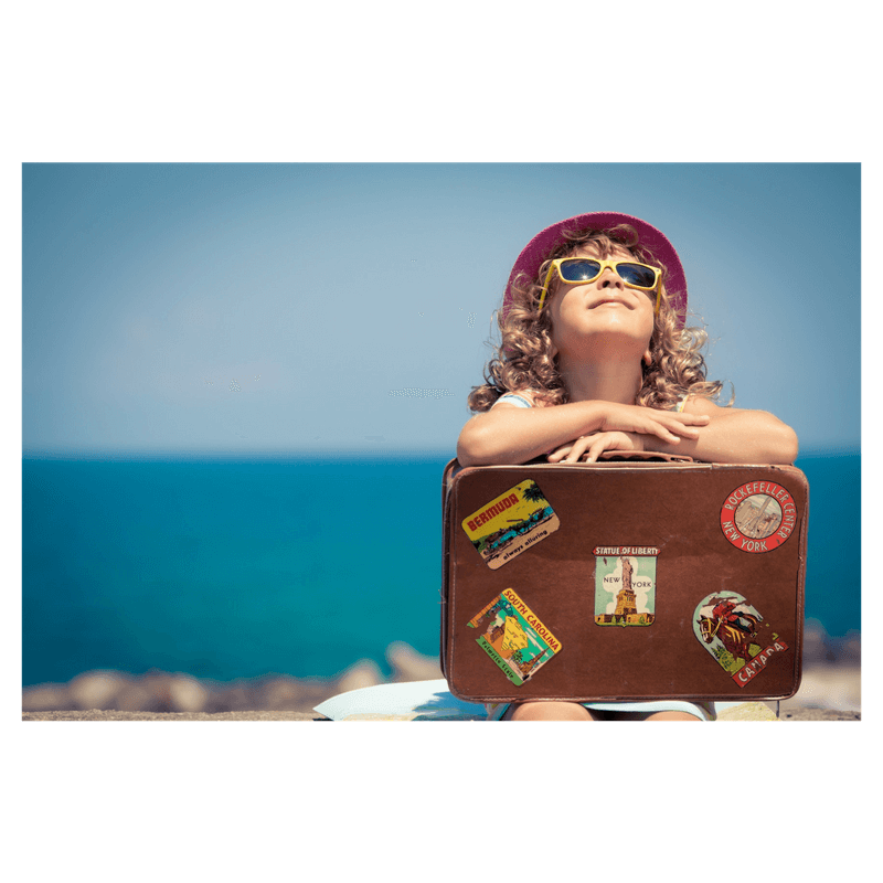 toddler girls with a bag at the beach wearing sunglasses and a hat