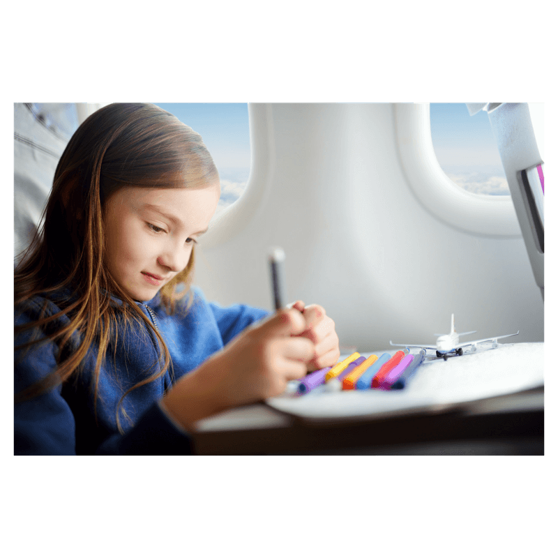 girls sittting on airplane playing and drawing