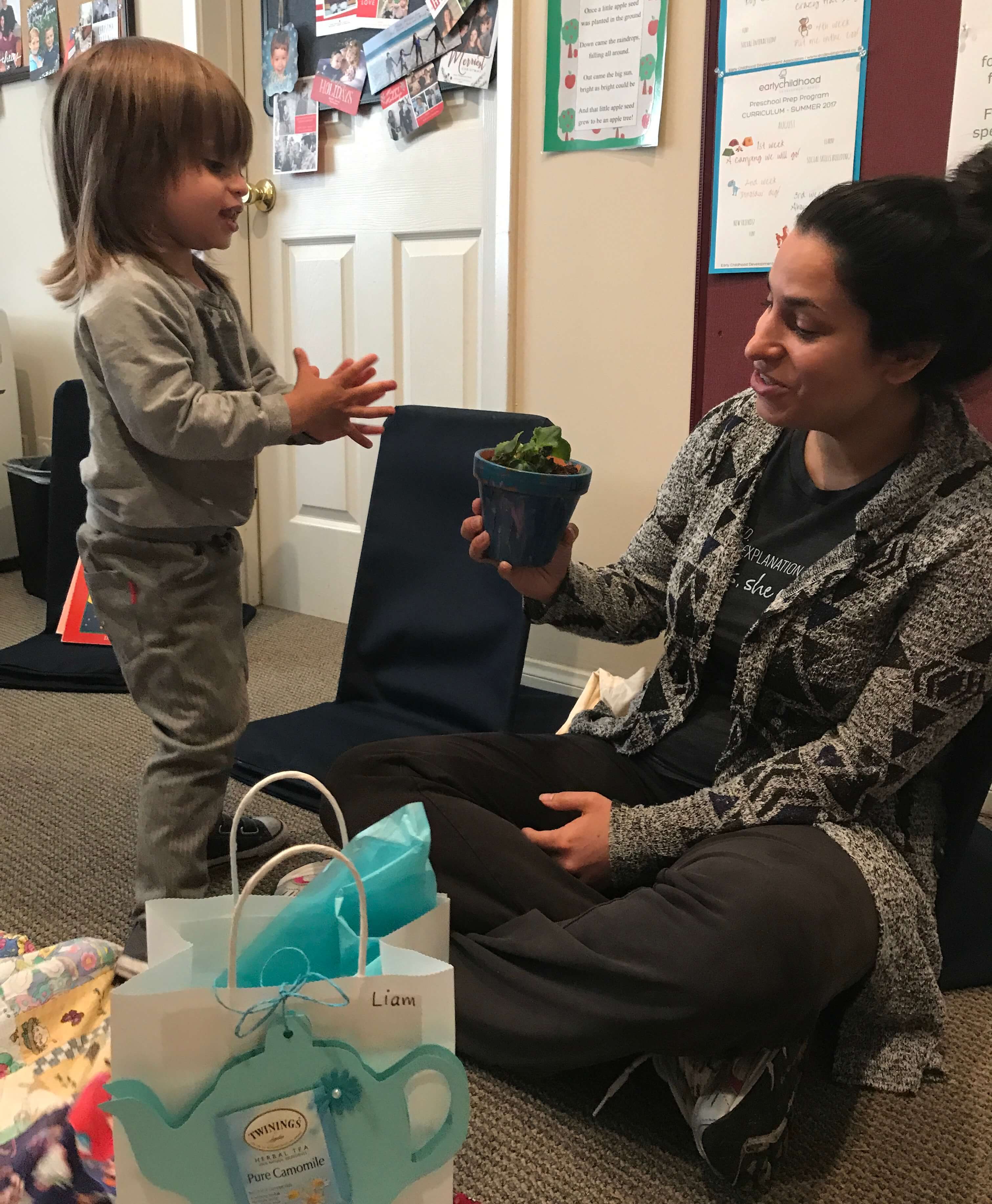 toddler giving mom a mother's day gift that he made at early childhood development associates' class