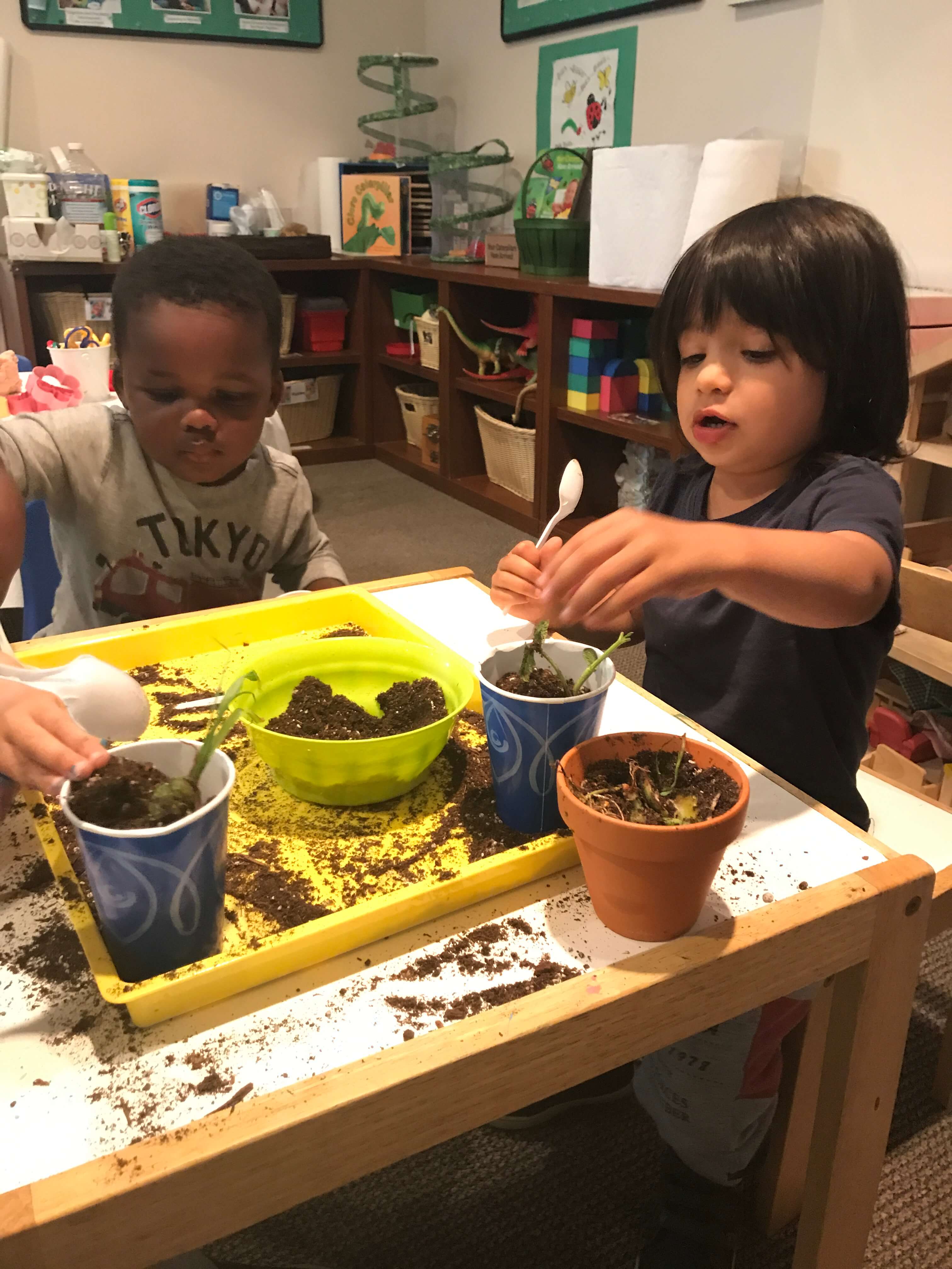 toddler paiting pot at early childhood development associates' class