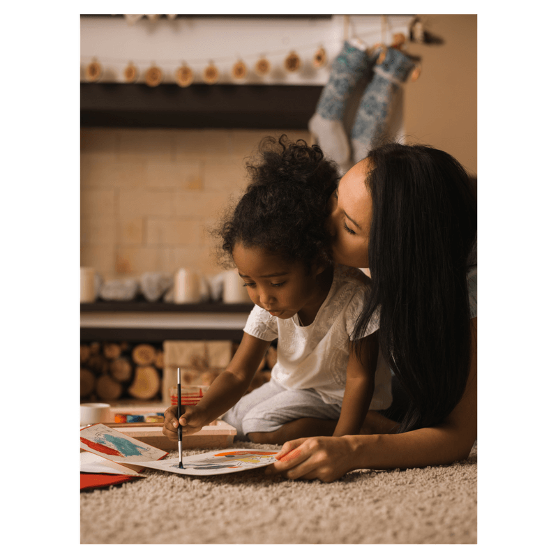 mom and daughter drawing together, mom is kissing her