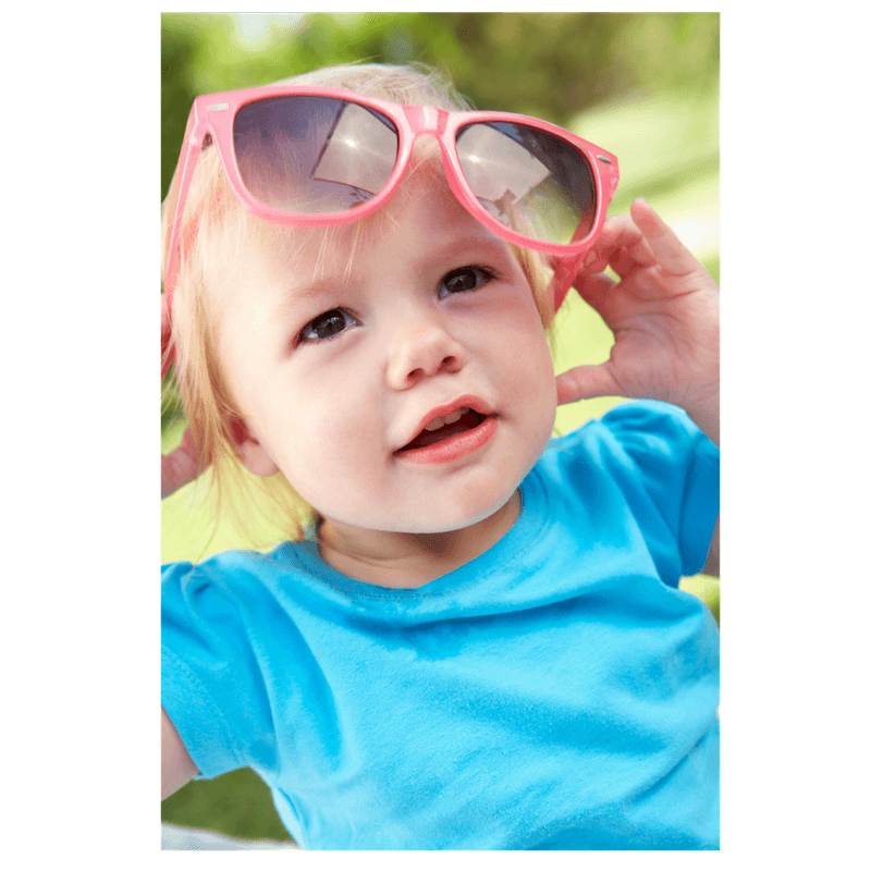little girl playing with sunglasses imitating mom