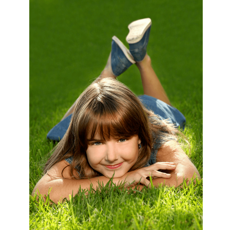 girl lying on the grass at the park