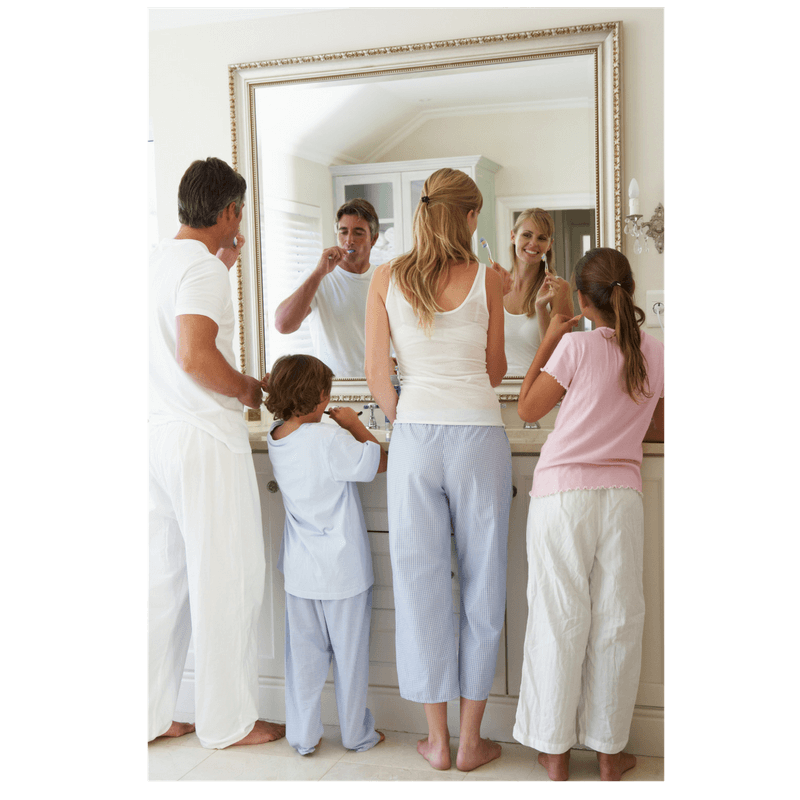 family of mom, dad and 2 kids bushing teeth together