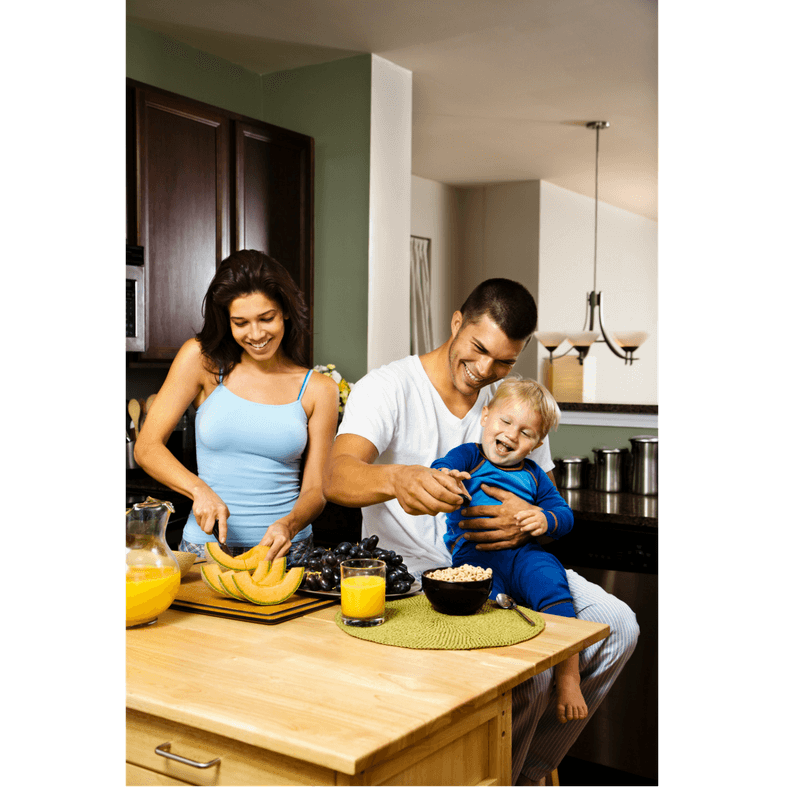 mom dad and toddler at the kitchen cooking together