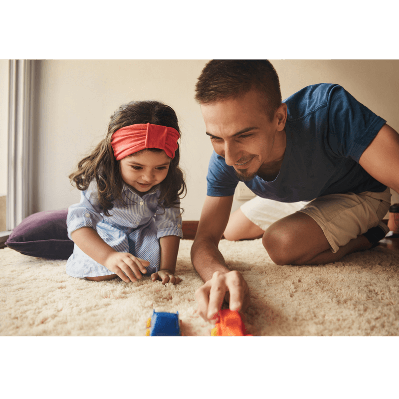 dad and toddler daughter playing cars and talking