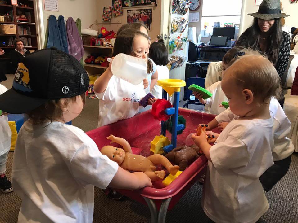 3 children playing with water at sensory table at Early Childhood Development Associates' class