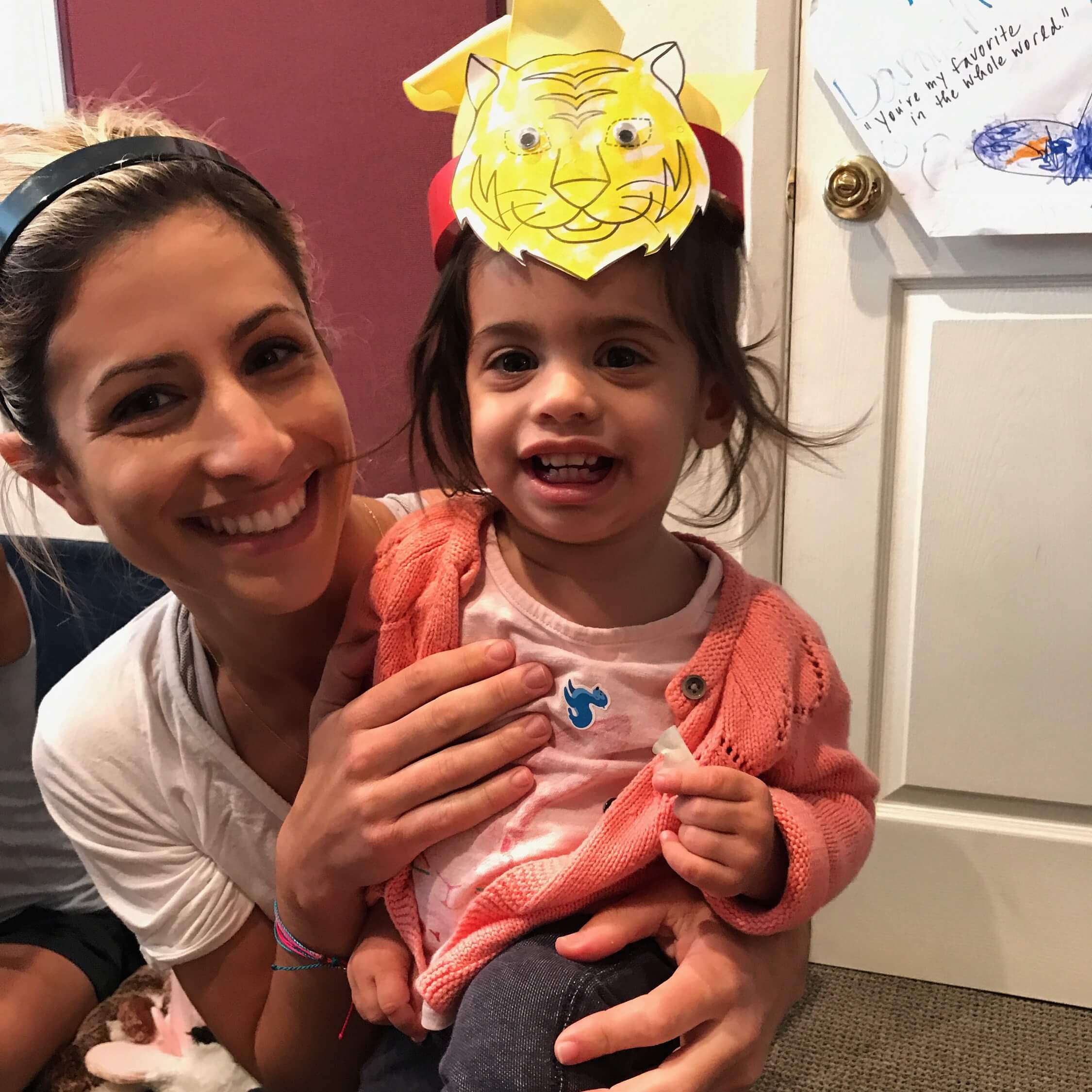 child and mom wearing tiger hat at Early Childhood Development ASsociates' class