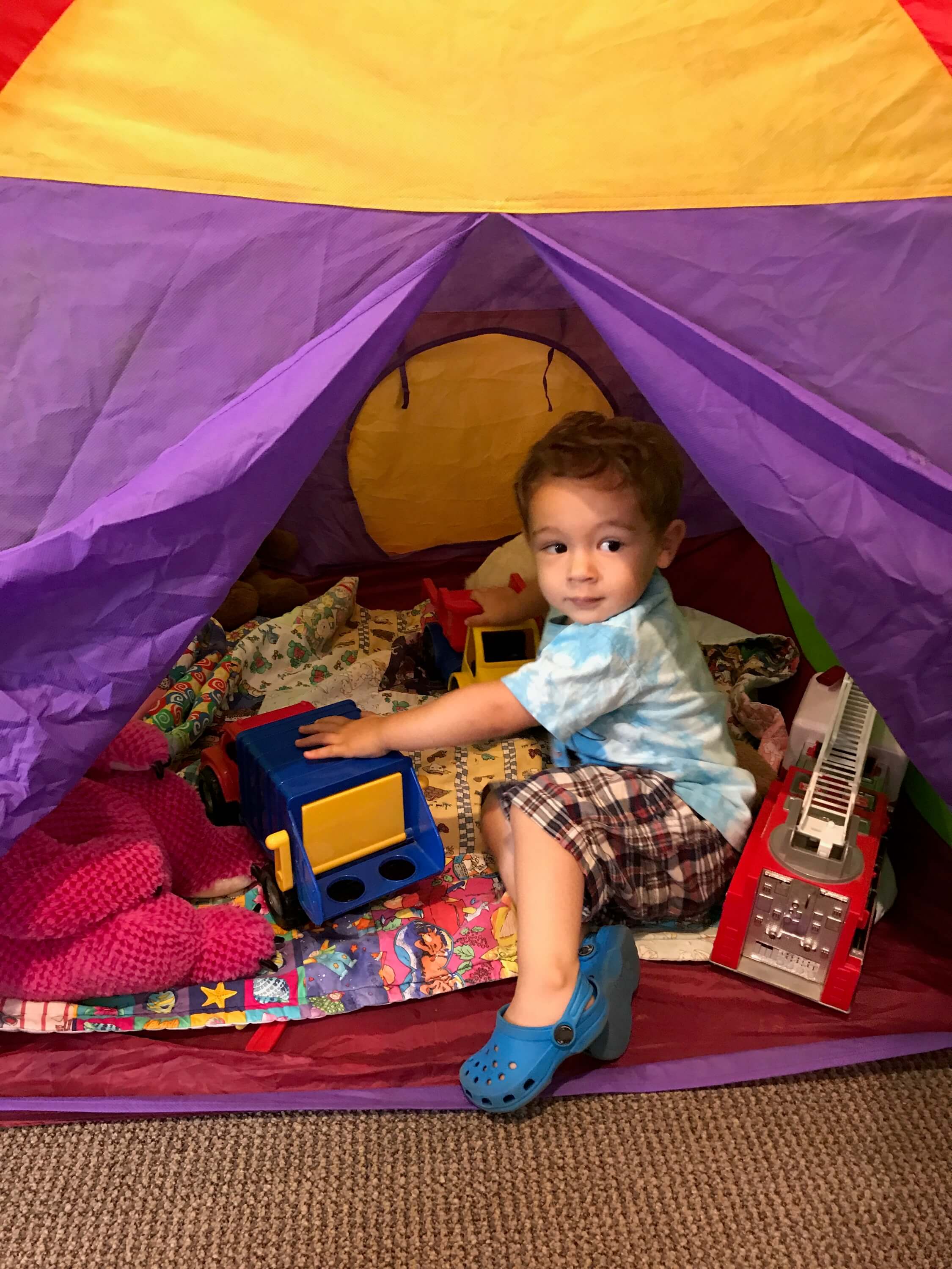 toddler playing in the tent at Early Childhood Development Associates Class