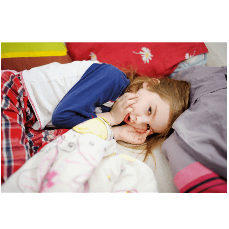 little girl lying in bed, doesn't want to leave